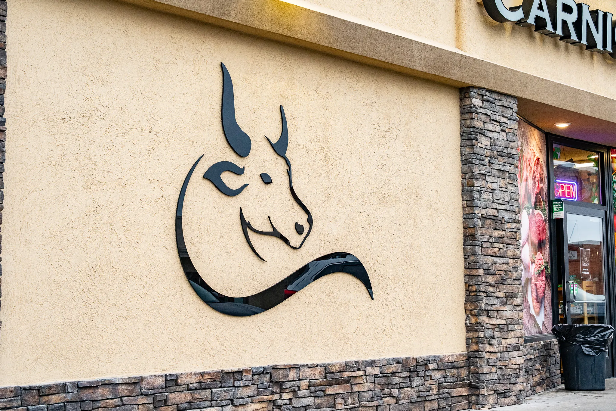 The Carnicería 99 bull-head logo mural mounted on the market’s exterior wall